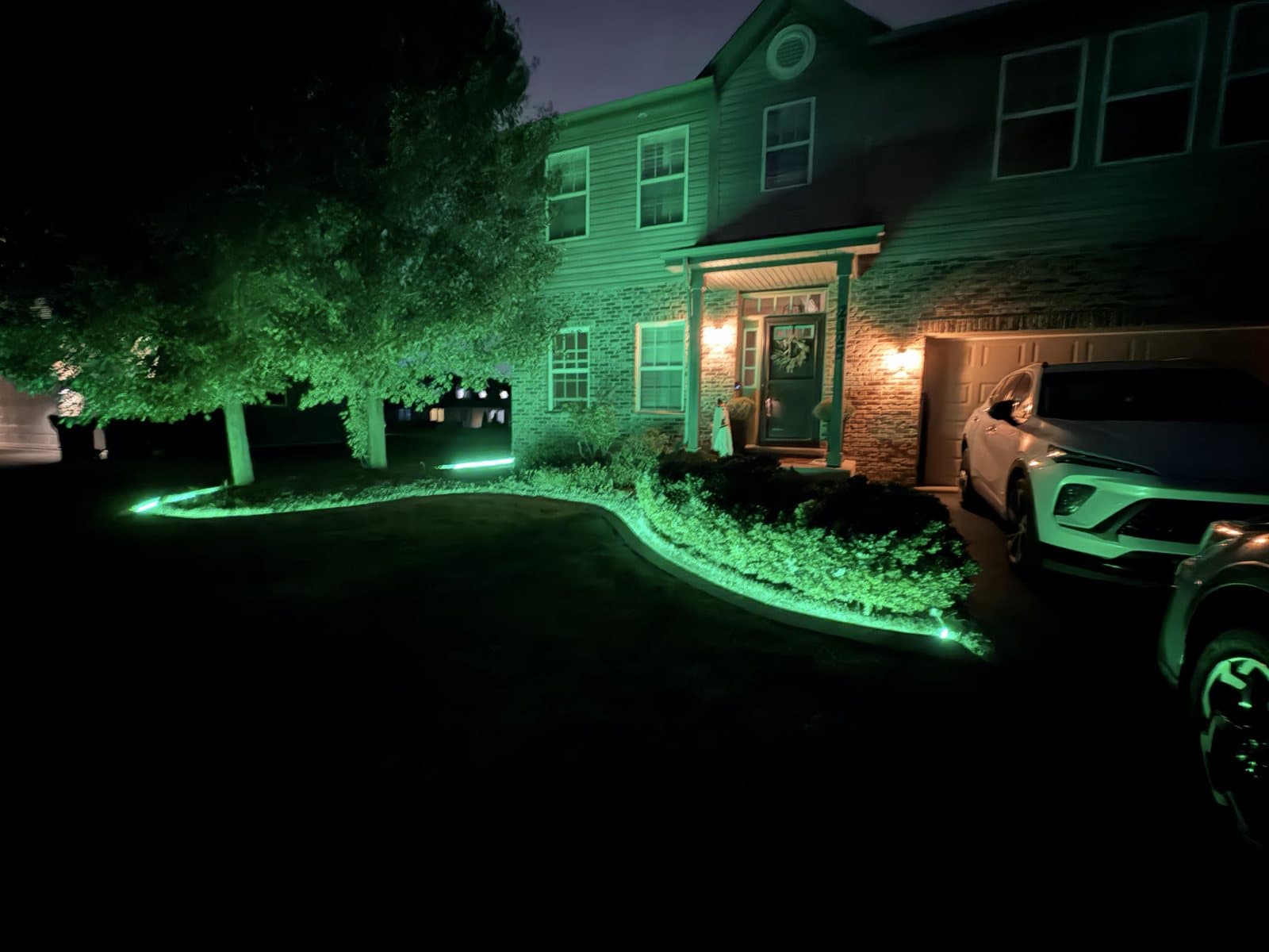 Concrete curb lit green at night