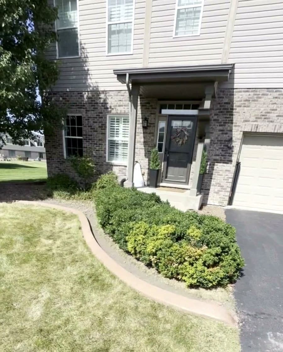 Concrete edging around a front entry bed