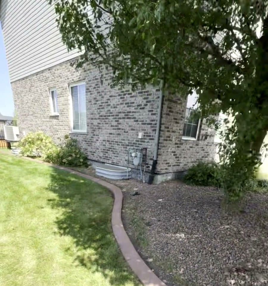 Concrete edging around a side yard bed