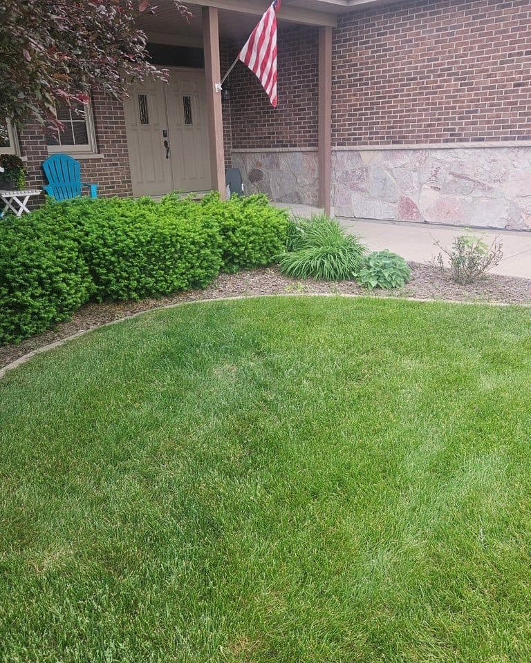 Trimmed bed along a front porch